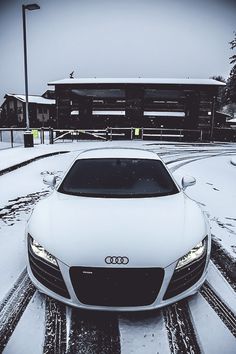 a white car is parked in the snow