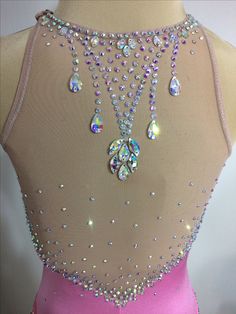 the back of a pink dress with jewels on it