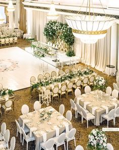 a banquet hall with tables and chairs set up for an event