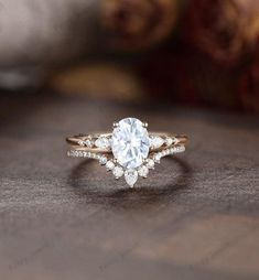 an engagement ring with a pear shaped diamond on top