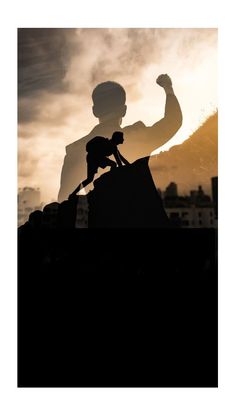 the silhouette of a man on top of a horse with his arm in the air