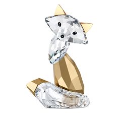 a crystal cat figurine sitting on top of a white surface with gold accents