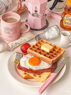 a plate topped with waffles, eggs and bacon