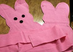 a pink paper towel with black buttons on it and some bunny ears sticking out of it