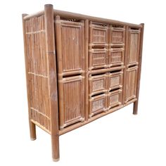 an old bamboo cabinet with drawers on it's sides and wooden legs, against a white background