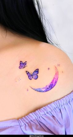 a woman's shoulder with two butterflies on it and the moon in the sky