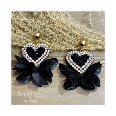 Sparkly Black Heart Earrings!! These earrings are so pretty and will definitely brighten up your outfit.   They are made with sparkly black crystals and rhinestones with a silk flower petals at the bottom.    These measure around 2.5" x 1.5". Please note the color intensity of the beads may vary slightly from what is shown due to computer monitor settings and bead availability. Please note the color intensity of the beads may vary slightly from what is shown due to computer monitor settings and Black Heart Earrings, Heart Crystal, Sparkly Earrings, Business Card Size, Earrings Black, Black Earrings, Silk Flower, Black Heart, Black Crystals