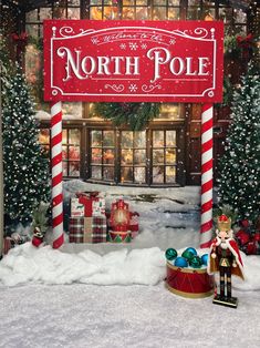 the north pole sign is decorated with candy canes