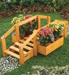 wooden planters with flowers in them on the grass