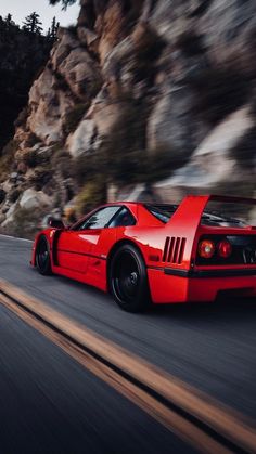 a red sports car driving down the road