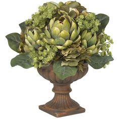 a vase filled with lots of green flowers