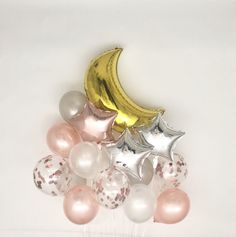 a bunch of balloons and a banana sitting on top of each other in front of a white wall