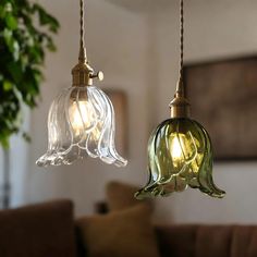 two glass lights hanging from a ceiling in a living room