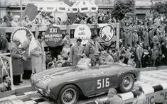 an old black and white photo of a race car