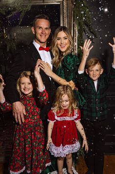 two children and an adult are posing for a christmas card