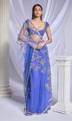 Crafted with meticulous detailing, this deep blue organza sari is richly adorned with metallic accents, crystals, and sequins forming floral patterns while the pre-stitched tulle bottom features delicate scattered embroidery. Complementing the ensemble, the blue georgette blouse is detailed with metal circles, pearls embroidery, and intricate cutwork. Engagement Sarees, Blue Sari, Reception Sarees, Papa Don't Preach, Green Sari, Haldi Dress, Blue Organza, Bridal Jumpsuit, Wedding Jumpsuit