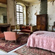 an old bedroom with pink bedding and furniture in the room that has been torn down