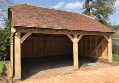 a large wooden shed with a brick walkway