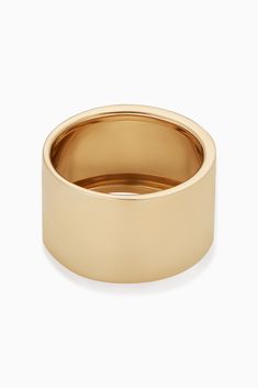 Radiant. Bold. Timeless. Our High Society Ring is a must-have for every fine jewelry collection. Our take on the classic cigar band, its wide, flattened solid gold tube gives it a classic, vintage, yet modern feel. Metal: 14 Karat Yellow Gold Dimensions: 12mm Width Available in multiple sizes Weight: 2.3 Grams Origin: Crafted in Arezzo, Italy Timeless White Gold Thick Band Ring, Classic Jewelry With Polished Finish And Wide Band, Classic Wide Band Jewelry With Polished Finish, Classic White Gold Thick Band Ring, 14k White Gold Wide Band Ring, Minimalist Wide Band With Polished Finish, Timeless Wide Band With Polished Finish, Minimalist Wide Band For Formal Occasions, Minimalist Formal Wide Band