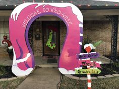 a welcome sign in front of a house decorated for the holiday season with candy canes