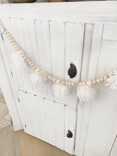 a white door with some tassels hanging from it