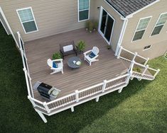 an aerial view of a deck with chairs and grill