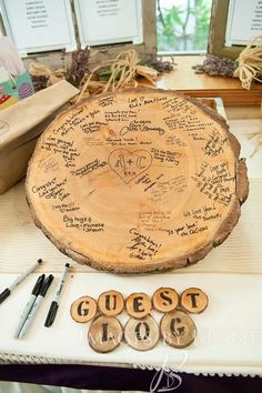 a table topped with lots of writing on top of a wooden slice