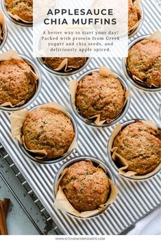 freshly baked muffins sitting on a cooling rack next to cinnamon sticks and spices