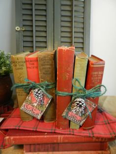 several old books tied up on top of each other in front of a window with shutters