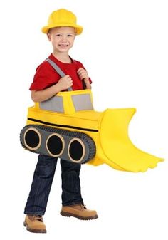 a young boy wearing a construction worker costume and holding a large yellow bulldozer