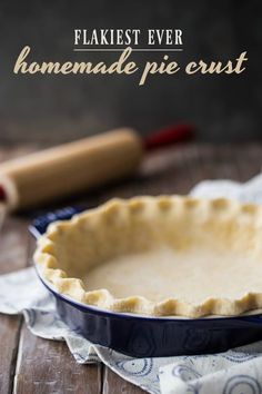 an uncooked pie crust in a blue dish on a wooden table with the words flakiest ever homemade pie crust