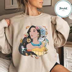 Disney Pocahontas Princess Sweatshirt White Disney Character Print Sweatshirt For Fan Events, White Graphic Print Sweatshirt For Disney Fan Events, Disney Crew Neck Sweatshirt For Fans, White Disney Crew Neck Sweatshirt, Disney White Sweatshirt With Cartoon Print, Modern Pocahontas Outfit, White Disney Character Print Sweatshirt, Disney Crew Neck Sweatshirt Fan Merchandise, White Disney Graphic Print Sweatshirt