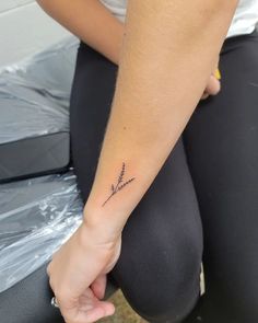 a woman with a small tattoo on her arm