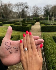 two people holding each other's hands with tattoos on their fingers and the words she said yes