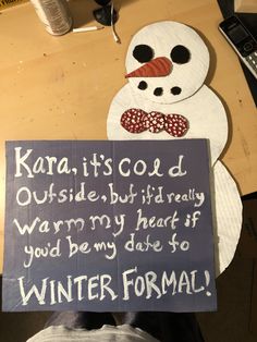 a paper plate snowman holding a sign that says, karani it's cold outside but literally warm my heart if you'd be my date to winter formal