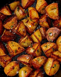 cooked potatoes with parmesan cheese and seasoning in a skillet