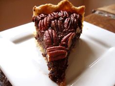 a piece of pecan pie on a white plate