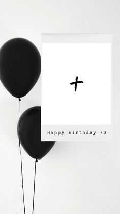 two black balloons are in front of a birthday card