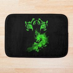 a black and green bath mat with an image of a deer on it's face