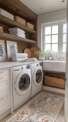 a washer and dryer in a small room with wooden shelves on the wall