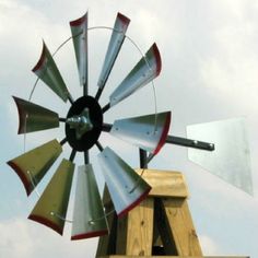 an old fashioned windmill on top of a wooden structure