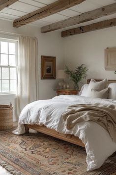 a bedroom with a large bed and wooden beams in the ceiling, along with a rug on the floor