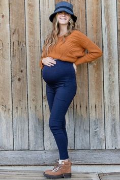 These Comfy Maternity Jeggings offer the perfect blend of comfort and style. The extra tall waistband and seamless stretch maternity panel provide maximum support and coverage for your growing tummy, and the pull-on closure ensures an easy and secure fit. Plus, rated for top fit and comfort, you can be sure you look and feel great all day long.Product Features:Seamless Stretch Maternity PanelNon-LinedFits Like Wearing Leggings with the Look of Wearing JeansSizing:One Size Fits Pant Size 0-10Model is in her third trimester and loves these pantsTotal Length: 40.5"Inseam: 26.5"Note:Items are Hand Dyed and may Vary From Batch to BatchWe configure our screens for the most accurate color display. Screen settings vary and may not display colors the same.We do not offer personalization on this lis Pregnant Outfits, Jumper Denim, Holiday Leggings, Legging Fits, Third Trimester, Scarf Poncho, Maternity Clothing, Color Display, Winter Tops