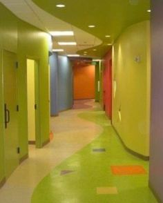 an empty hallway with brightly colored walls and flooring