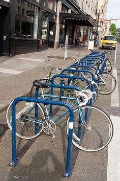 there are many bikes parked on the side of the street