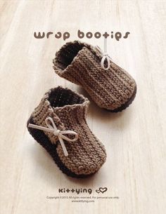 a pair of crocheted baby shoes sitting on top of a wooden floor