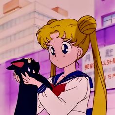 sailor girl holding a black cat in front of a building with chinese writing on it