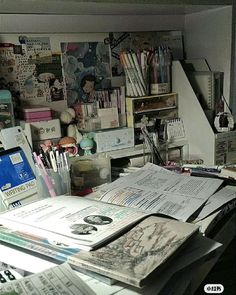 a cluttered desk with lots of papers on it