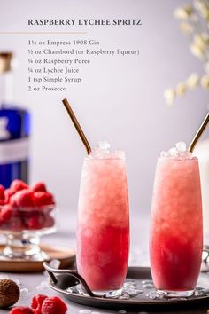 raspberry lychee spritz on a plate with two glasses filled with ice