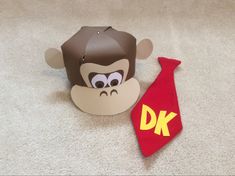 a paper hat and tie with a monkey on it